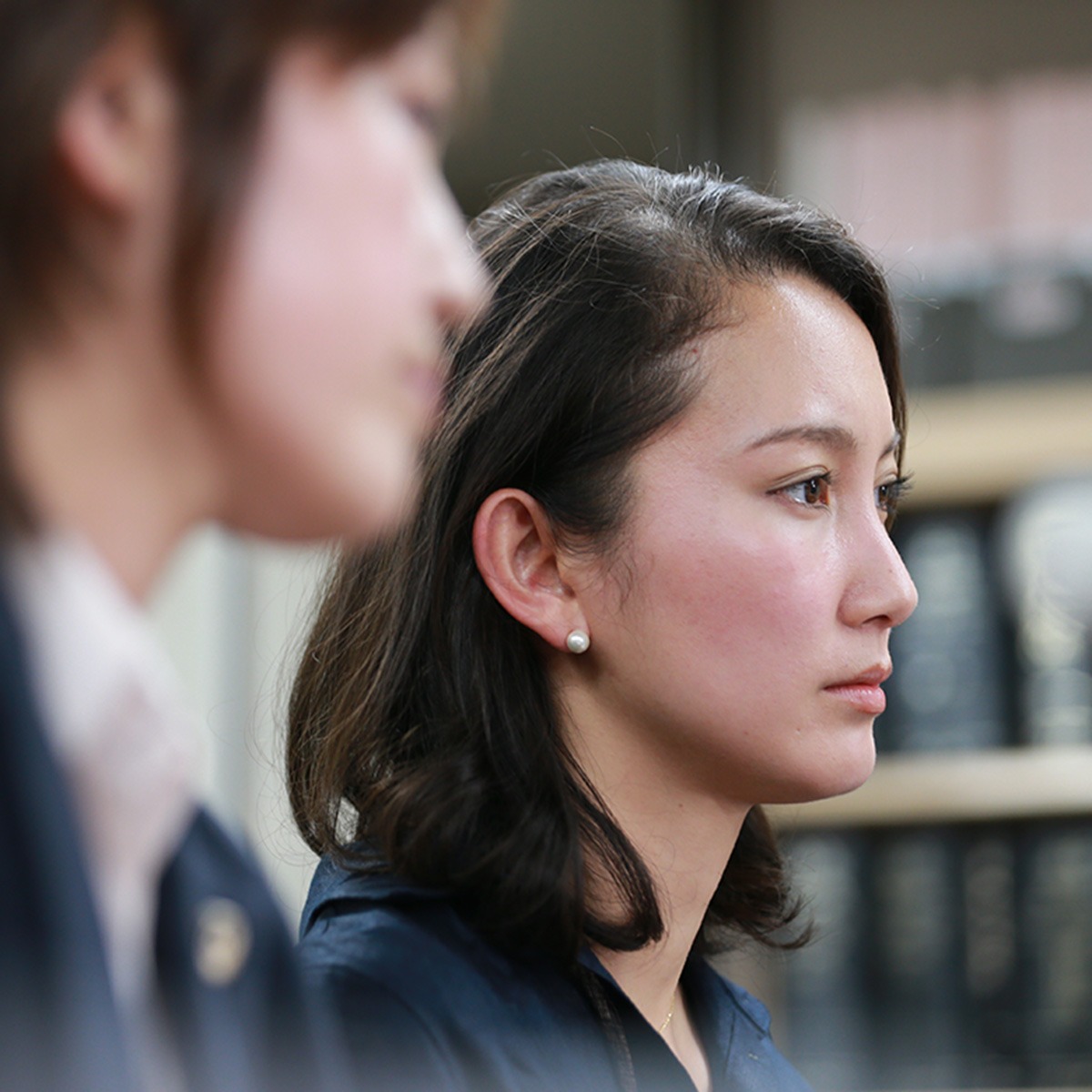 Two women sitting in a courtroom.