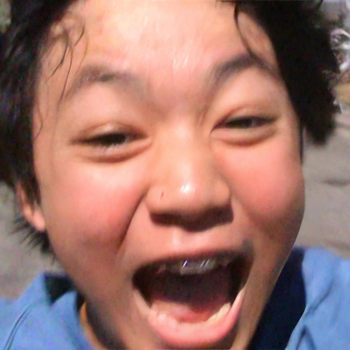 A boy running with a smile on his face.