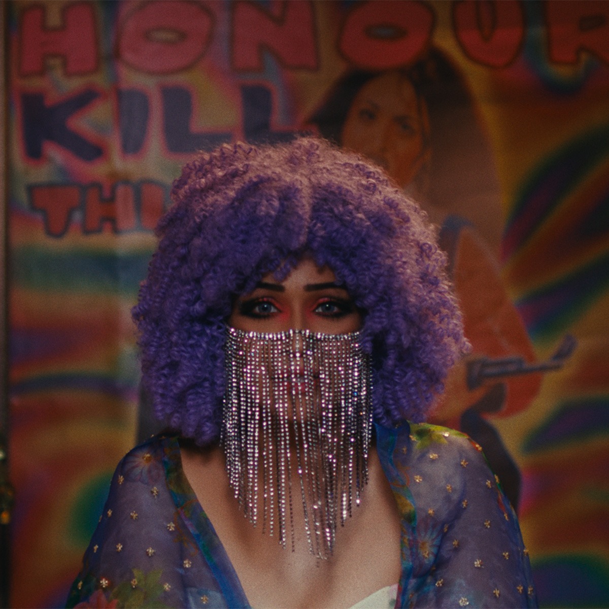 A woman with a purple wig in front of a store.