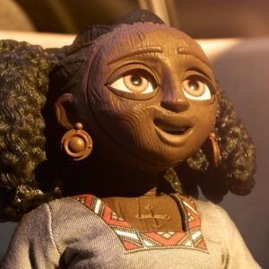 A woman with big earrings is smiling.